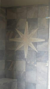 R&R Homes 4349 Yarrow Lane master bath poured shower floor - DalTile Ayers Rock porcelain tile with custom star design.