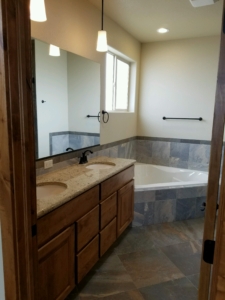 4349 Yarrow Lane master bathroom soaker tub and 2 sinks. Porcelain tile and upgraded 3cm granite countertop with under mount sinks.
