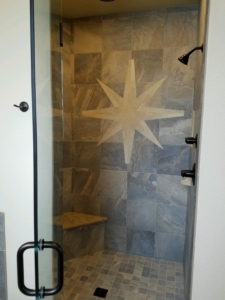 4349 Yarrow Lane master walk-in shower. Porcelain tile with granite bench and poured shower floor. Built-in niches for storage. Regular shower head and rainfall head in ceiling with diverter to control them.